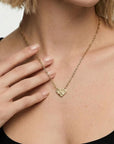model wearing 14k solid gold hammered heart necklace with diamonds