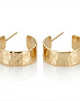Thick gold filled hoop earrings with wide hammered texture displayed on neutral flat lay background, handmade gold hoop earrings
