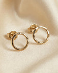 10mm hammered circle stud earrings in gold filled displayed on neutral flat lay background, minimalist handmade earrings