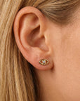 14k gold evil eye flat back earring styled on model ear stack