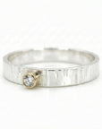 Mixed metal ring with hammered sterling silver band and 14k gold bezel diamond