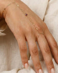Minimalist gold handlet bracelet with garnet stone, elegant hand chain jewelry for women