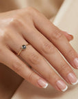 Model wearing dainty salt and pepper diamond ring in solid 14k gold, minimalist rustic stacking ring