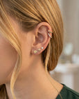 woman wearing 14k gold seashell stud earrings flat back cartilage piercing jewelry