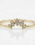 Curved diamond wedding band with crown tiara design, stackable contour ring with small diamonds, nesting enhancer band on neutral background