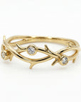 14k solid gold twig ring with small diamonds, nature inspired branch wedding band with organic texture displayed on neutral background