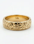 Wide 14k solid gold floral wedding band with textured botanical design, vintage style nature inspired ring displayed on neutral background