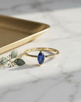 Handmade Marquise Blue Sapphire Ring: 14k Yellow Gold September Birthstone Jewelry shown in an AI-generated listing photo