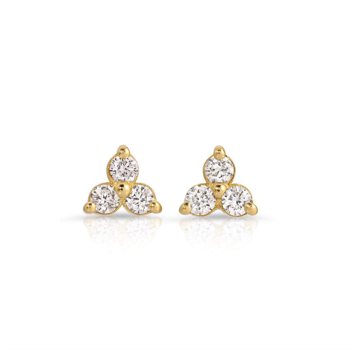 :A pair of gold earrings with three small diamonds each, arranged in a triangular shape.