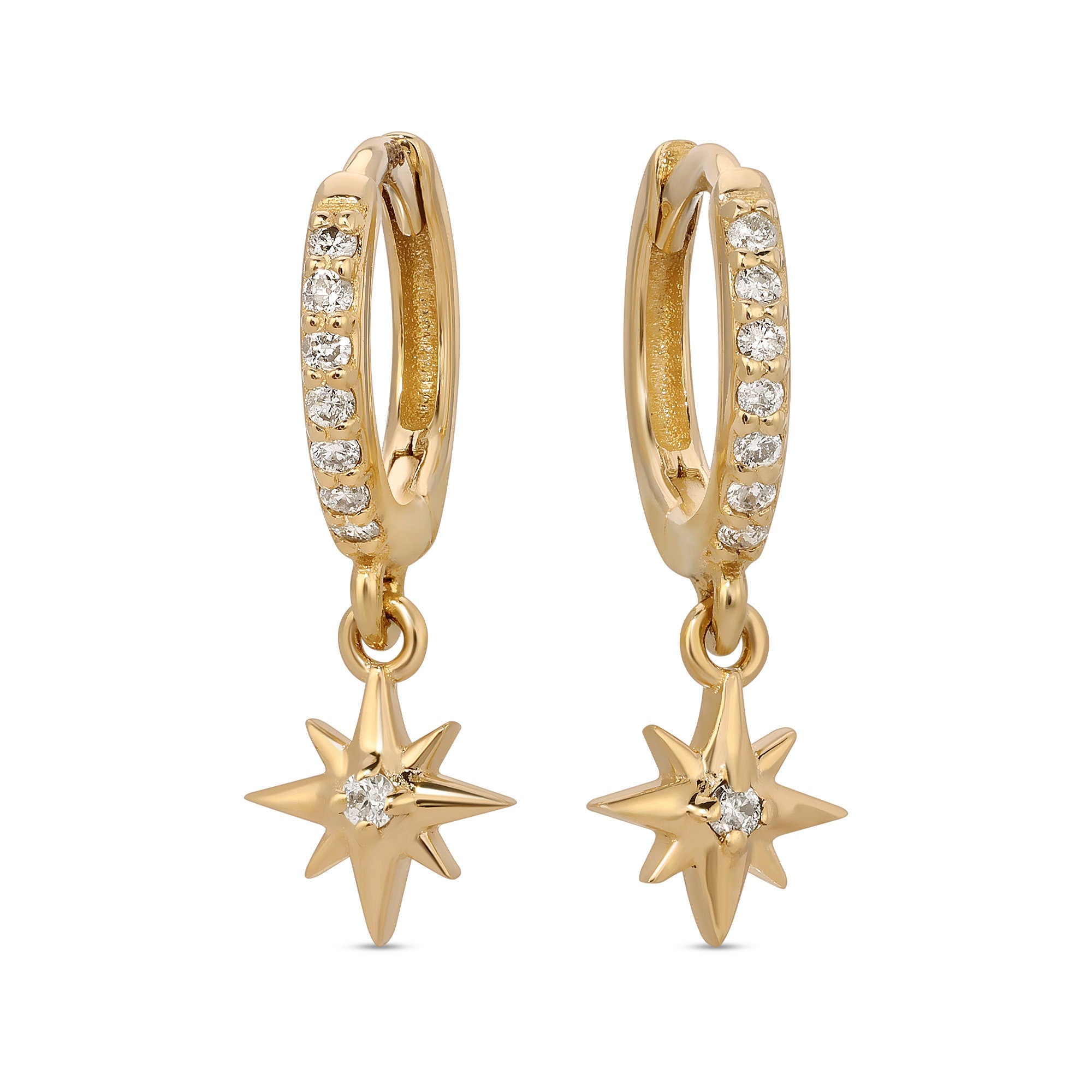 A pair of gold hoop earrings with a dangling star charm. Each hoop is adorned with a row of small, clear diamond stones. The star charms have a single clear diamond stone in the center.