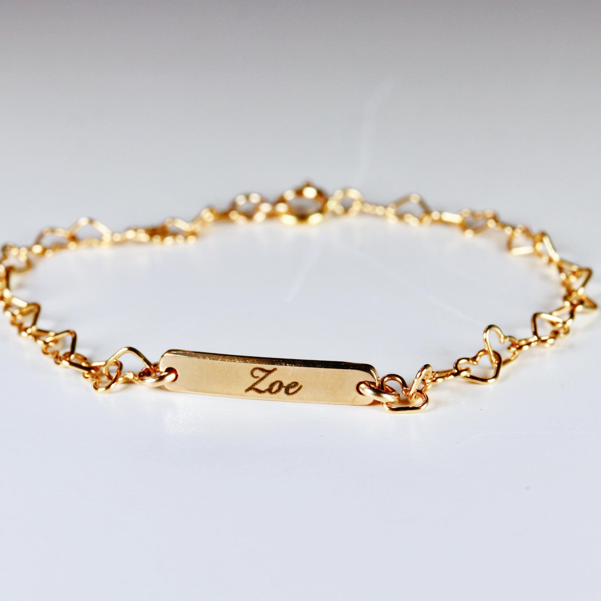 Custom gold filled bar bracelet with a child’s name engraved, shown on a white background. Dainty and personalized baby jewelry.