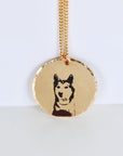 Gold filled round coin necklace engraved with a detailed photo portrait of a pet. Shown on a white background