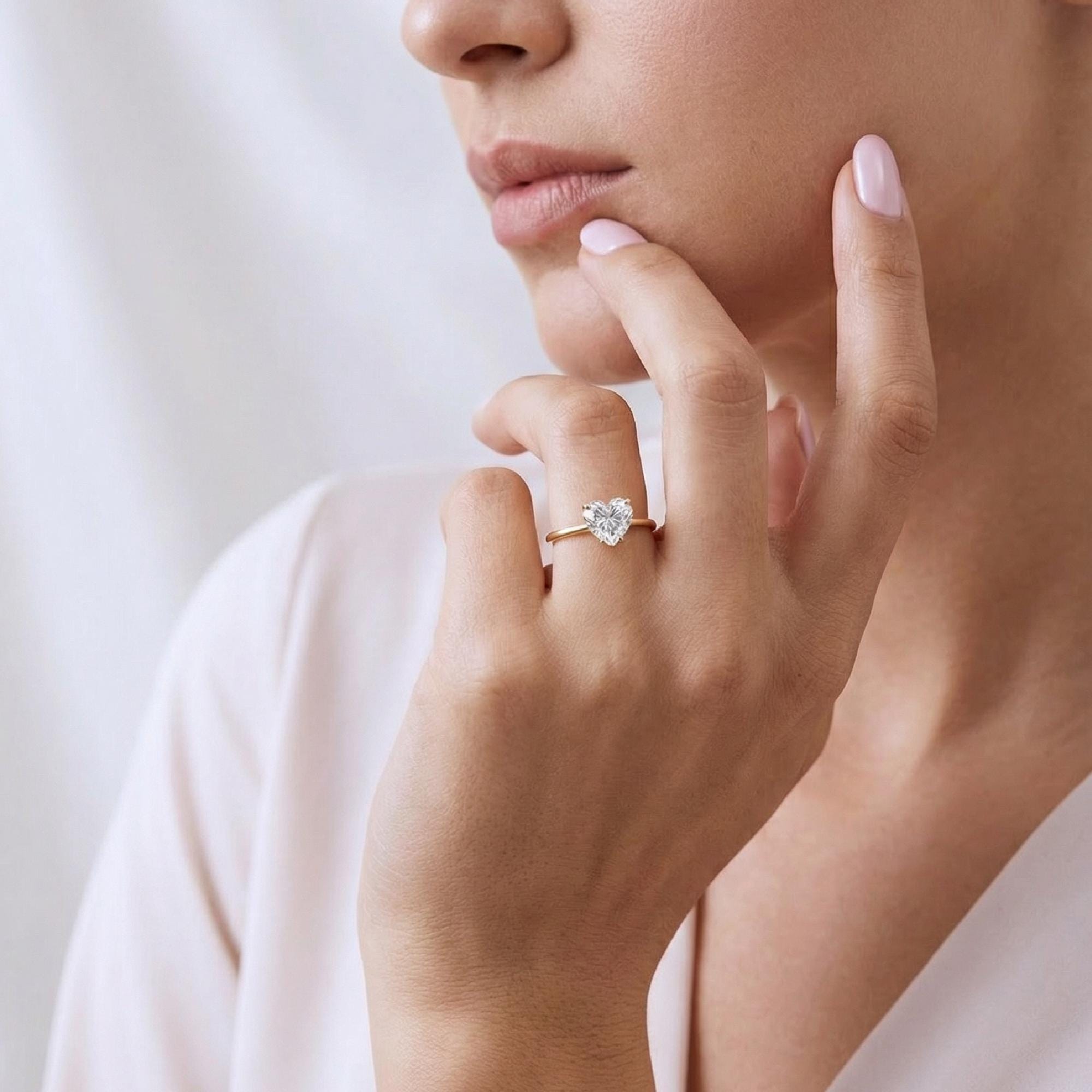 Model wearing Heart cut Moissanite Ring in 14k Gold.