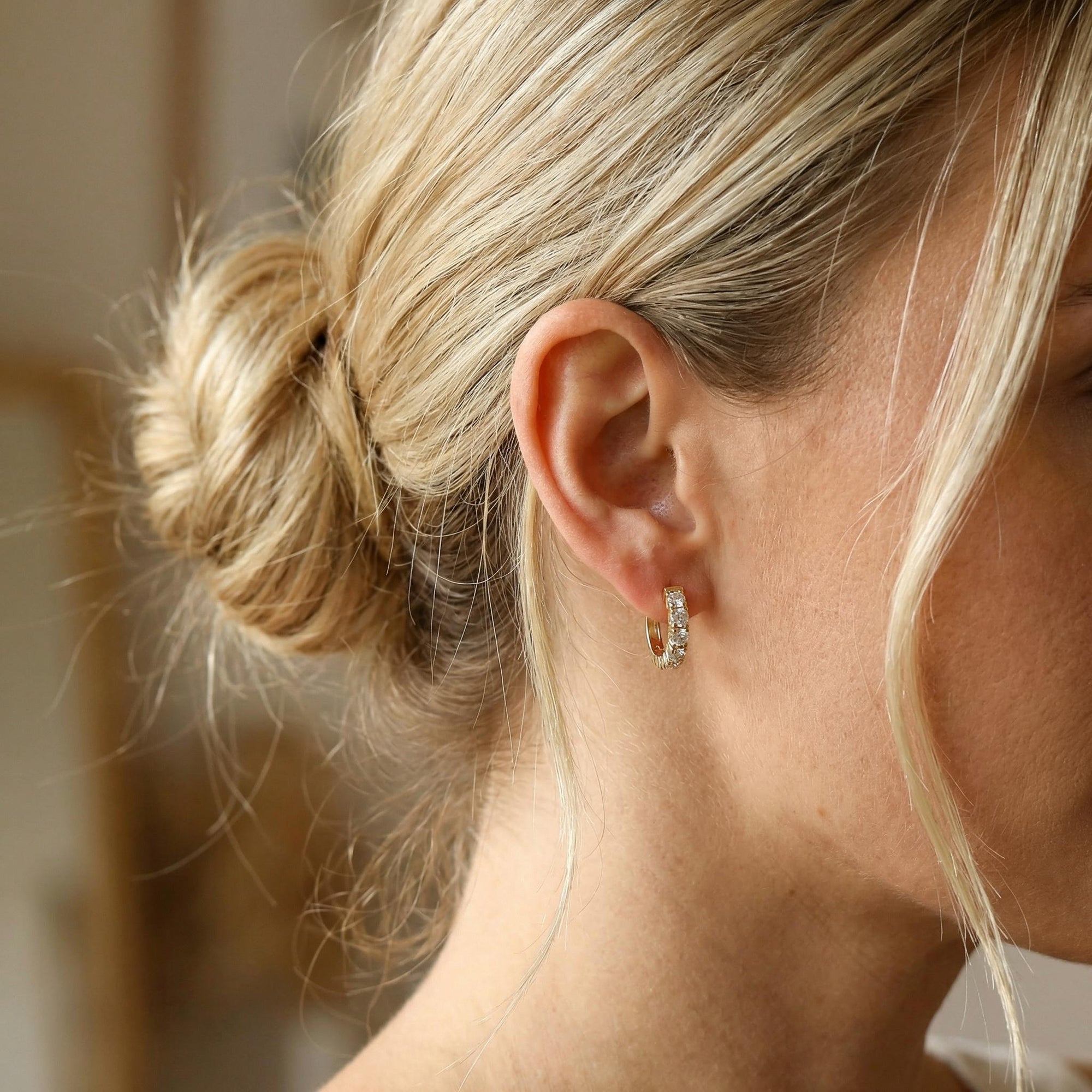 14k gold chunky diamond huggie earrings worn on ear, natural diamond hoops