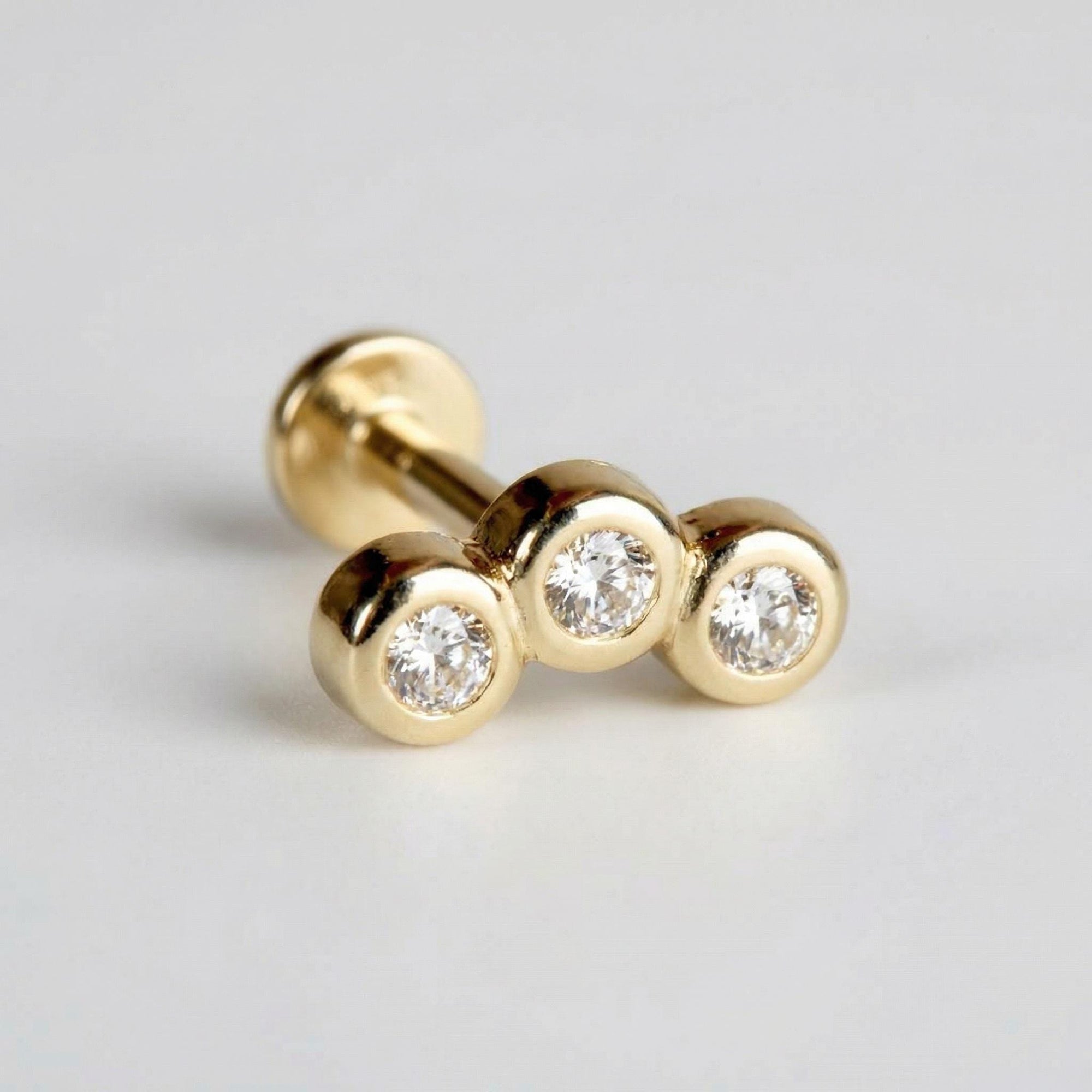 14k solid gold curved bar flat back earring with three bezel set CZ stones, internally threaded tragus cartilage stud