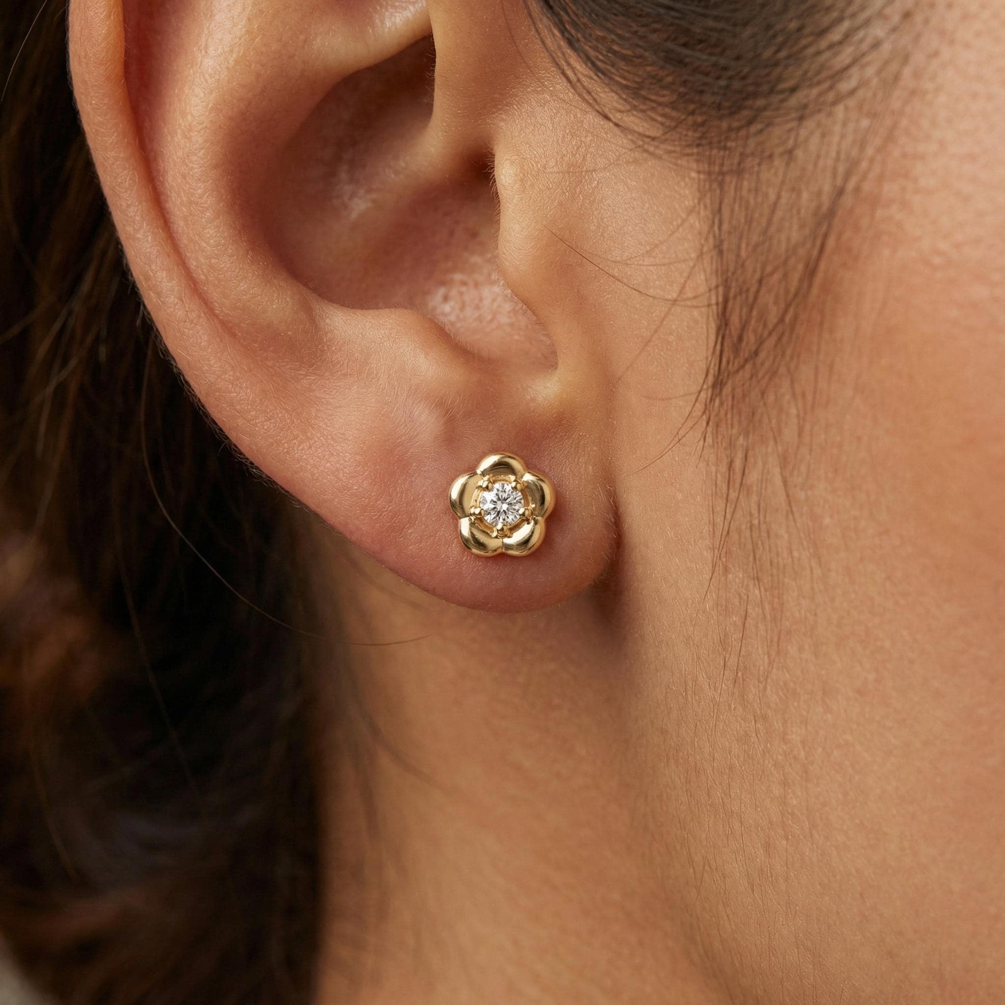 14k solid gold flower flat back earring worn in cartilage piercing, minimalist CZ gold ear stack stud