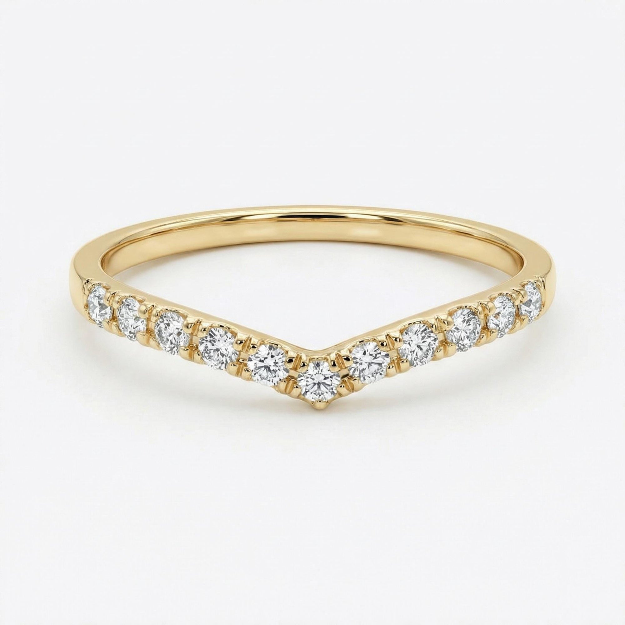 Curved diamond chevron wedding band in 14k yellow gold, V shaped contour ring with small diamonds, minimalist bridal stacking ring flat lay on neutral background