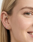14k solid gold tiny pizza slice flat back earring worn in tragus piercing, cute food themed ear stack stud with CZ diamond