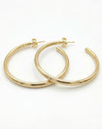 Large 30mm gold filled hoop earrings displayed on neutral flat lay background, 1 1/4 inch open round hoop earrings handmade