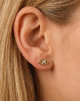14k gold evil eye flat back earring styled on model ear stack