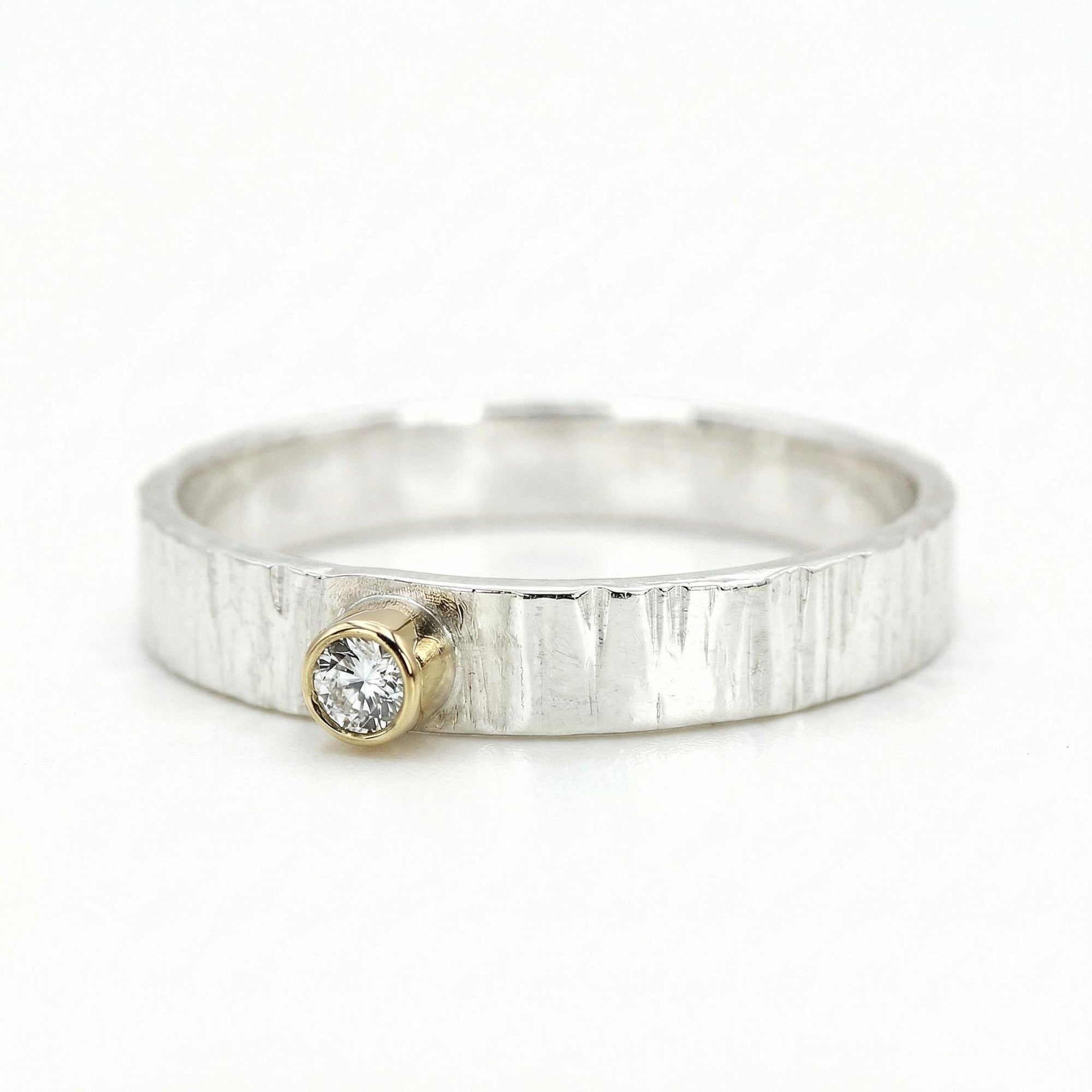Mixed metal ring with hammered sterling silver band and 14k gold bezel diamond