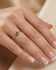 Model wearing dainty salt and pepper diamond ring in solid 14k gold, minimalist rustic stacking ring