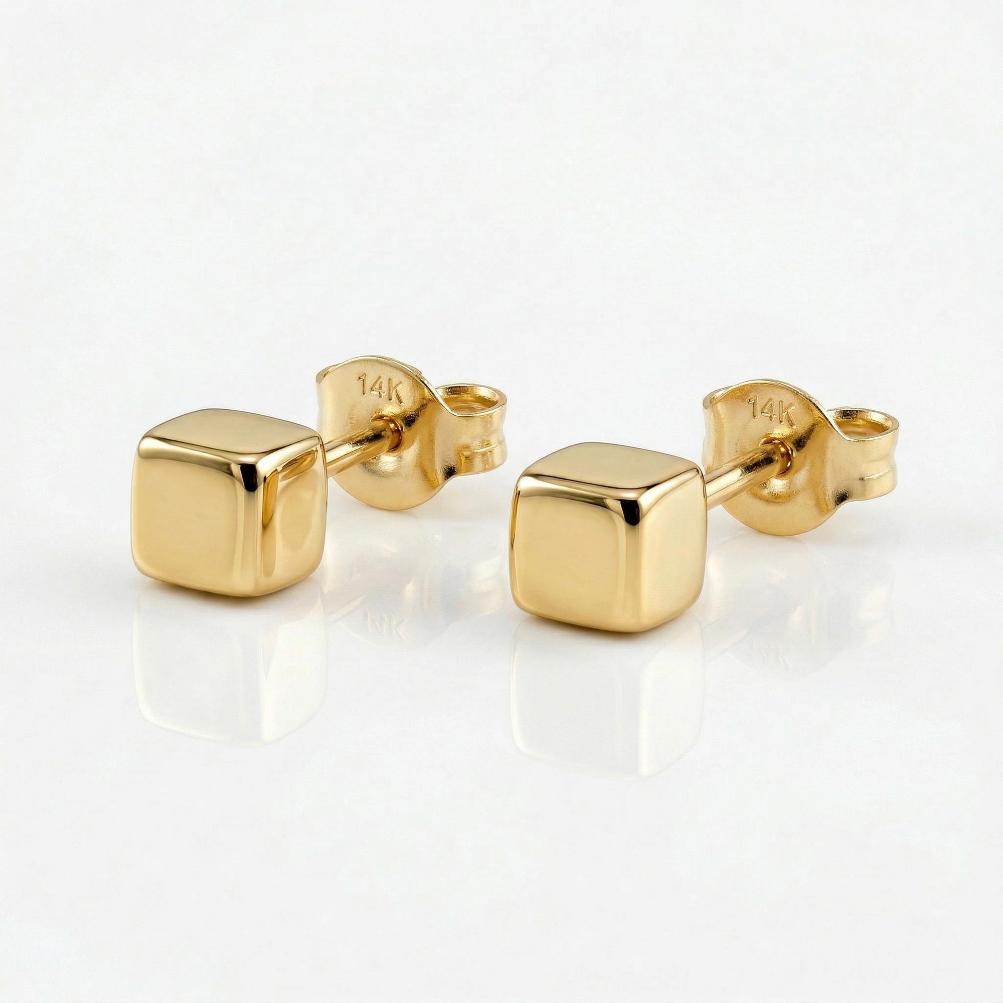 A pair of gold square stud earrings. The earrings are small and simple, with a minimalist design.
