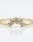 Curved diamond wedding band with crown tiara design, stackable contour ring with small diamonds, nesting enhancer band on neutral background