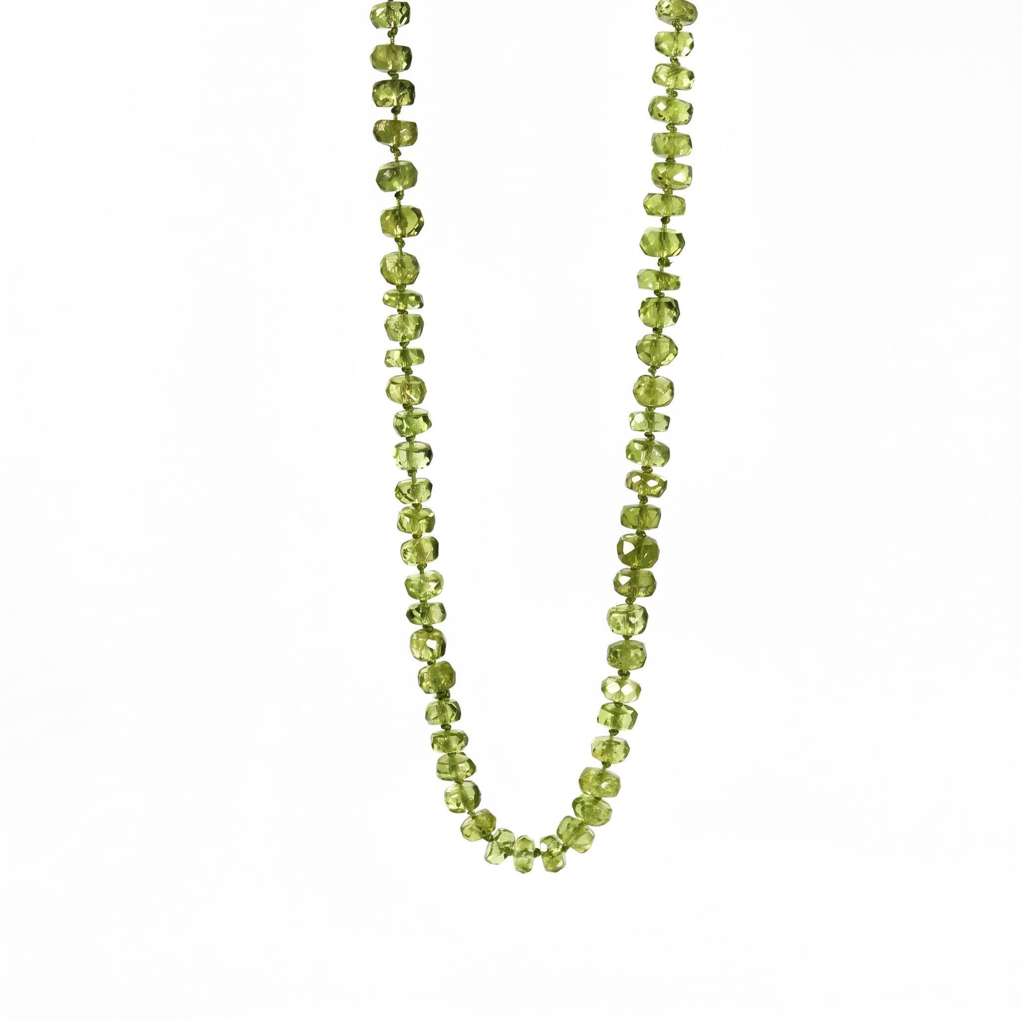 Hand knotted peridot August birthstone necklace on silk with gold filled lobster clasp laid flat on white background.