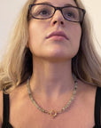 Prehnite silk hand knotted necklace worn at the neckline showing 20 inch length and figure eight charm holder clasp at the front.
