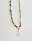 Close up of faceted prehnite rondelle beads, silk hand knotting and gold filled figure eight spring clasp.