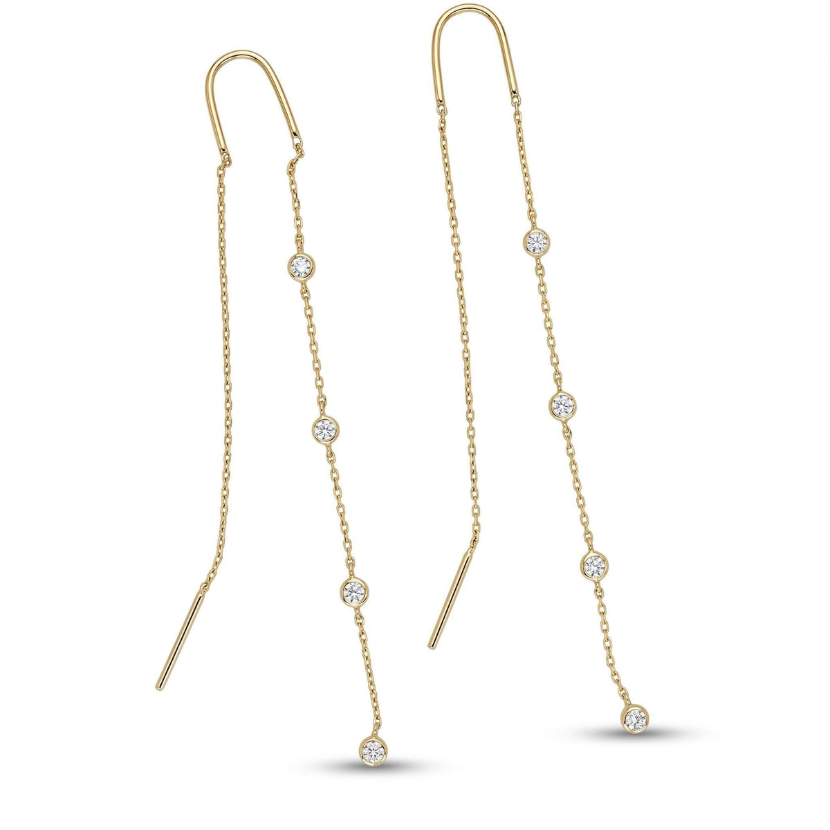 A pair of gold threader earrings with multiple bezel-set diamonds along the chains, presented on a white surface.