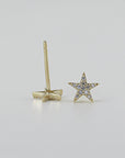Front and back views of a single star-shaped stud earring with paved stones and a thin post.