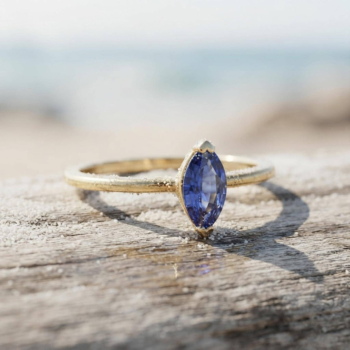 Handmade Marquise Blue Sapphire Ring: 14k Yellow Gold September Birthstone Jewelry shown in an AI-generated listing photo