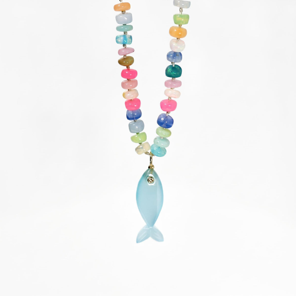 A colorful beaded necklace featuring multi-colored gemstones and a light blue fish charm suspended from the center against a white background.