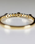 Close-up of the interior structure of a gold ring showing hollowed backing behind the stones.