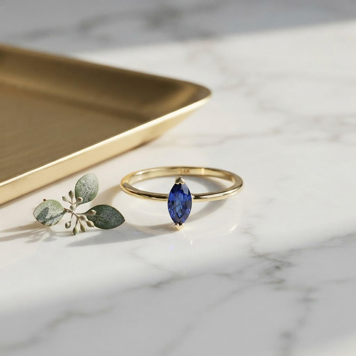 Handmade Marquise Blue Sapphire Ring: 14k Yellow Gold September Birthstone Jewelry shown in an AI-generated listing photo