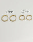 Four gold pave diamond hoop earrings displayed on a white surface, labeled with sizes 12mm and 10mm.